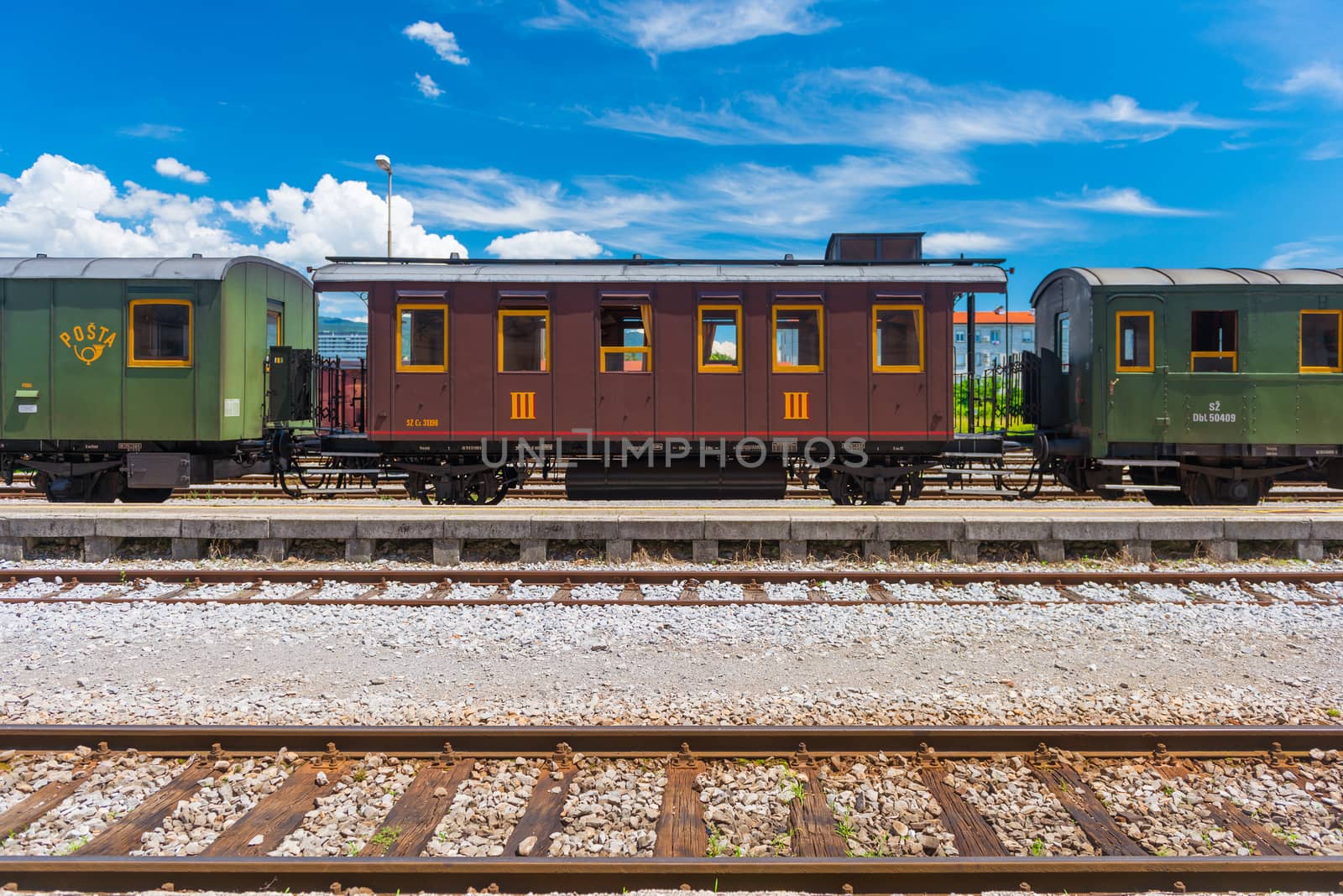 Nova Gorica (Gorizia) - June 2016, Italy: Vintage post-train cars on rails, old train at the station in Slovenian city of Nova Gorica. Sunny summer day