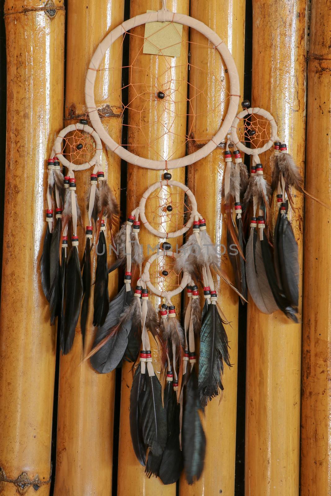 Real native dream catcher on pure natural wooden background.