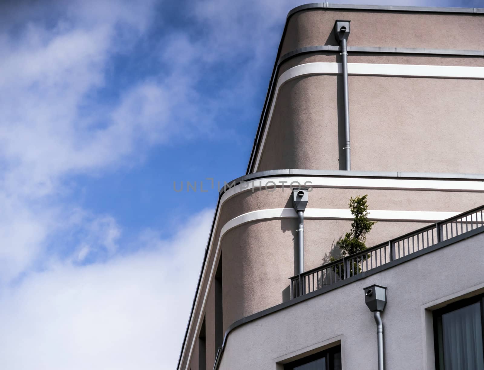 Abstract photo of the facade of a large building with three downpipes for rainwater flowing off the roof, germany
