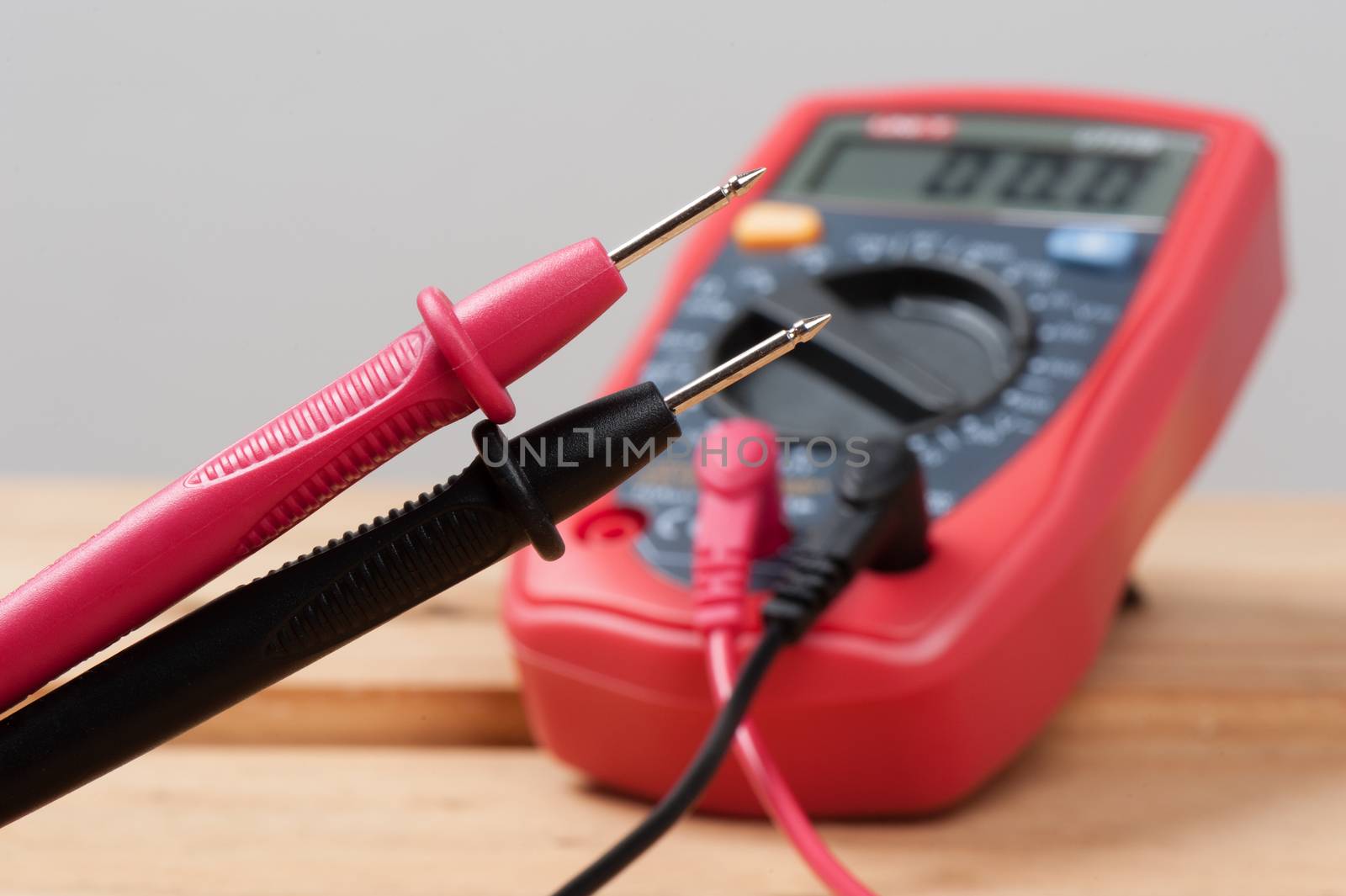 digital multimeter or multitester or Volt-Ohm meter (closeup at test leads), an electronic measuring instrument that combines several measurement functions in one unit.