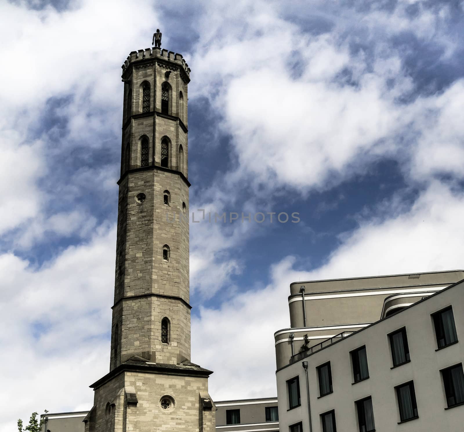 Old water tower in Braunschweig with the modern new building of a new hotel in the foreground, Germany