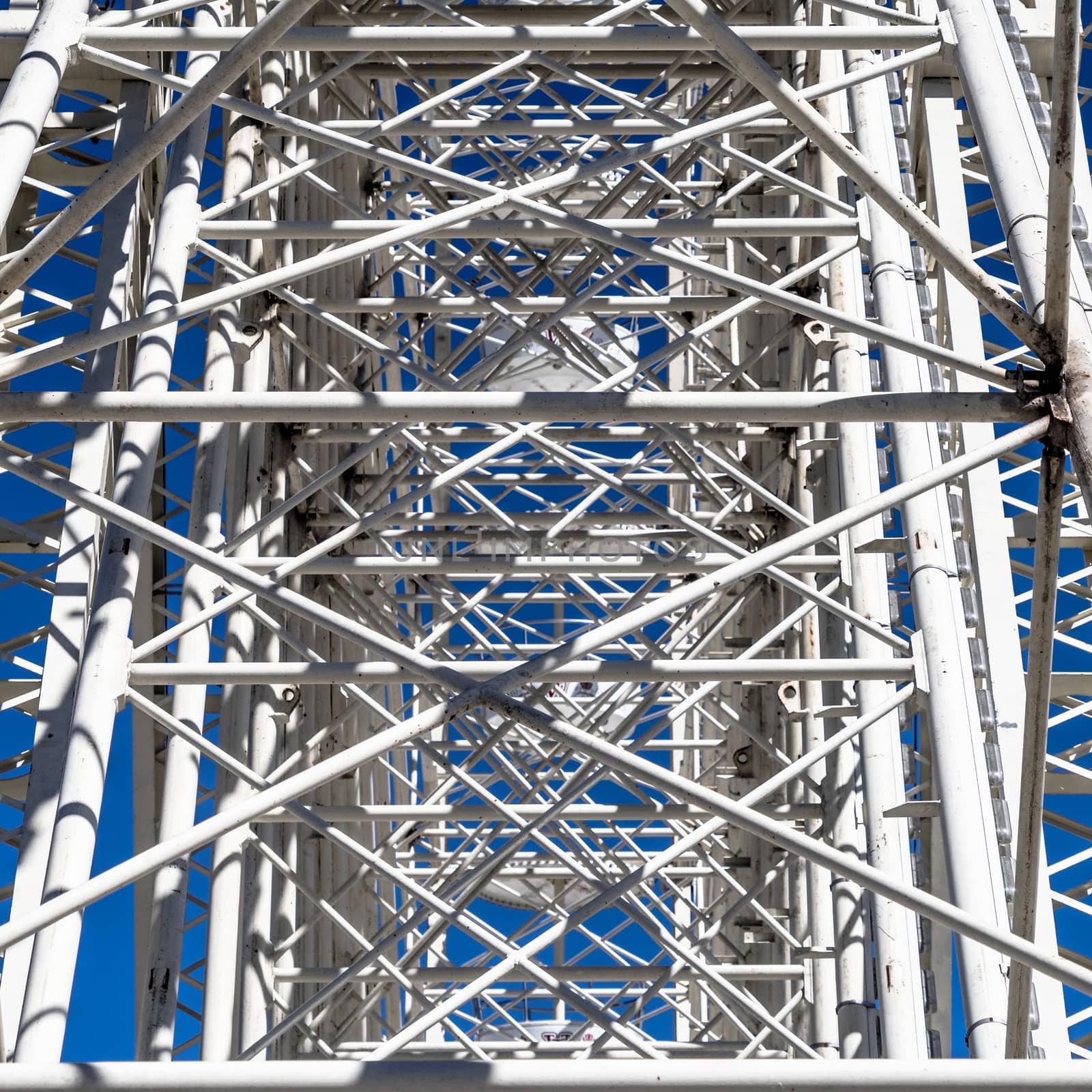 Abstract impression due to the confusing supports, struts and slats on the mount of a Ferris wheel by geogif