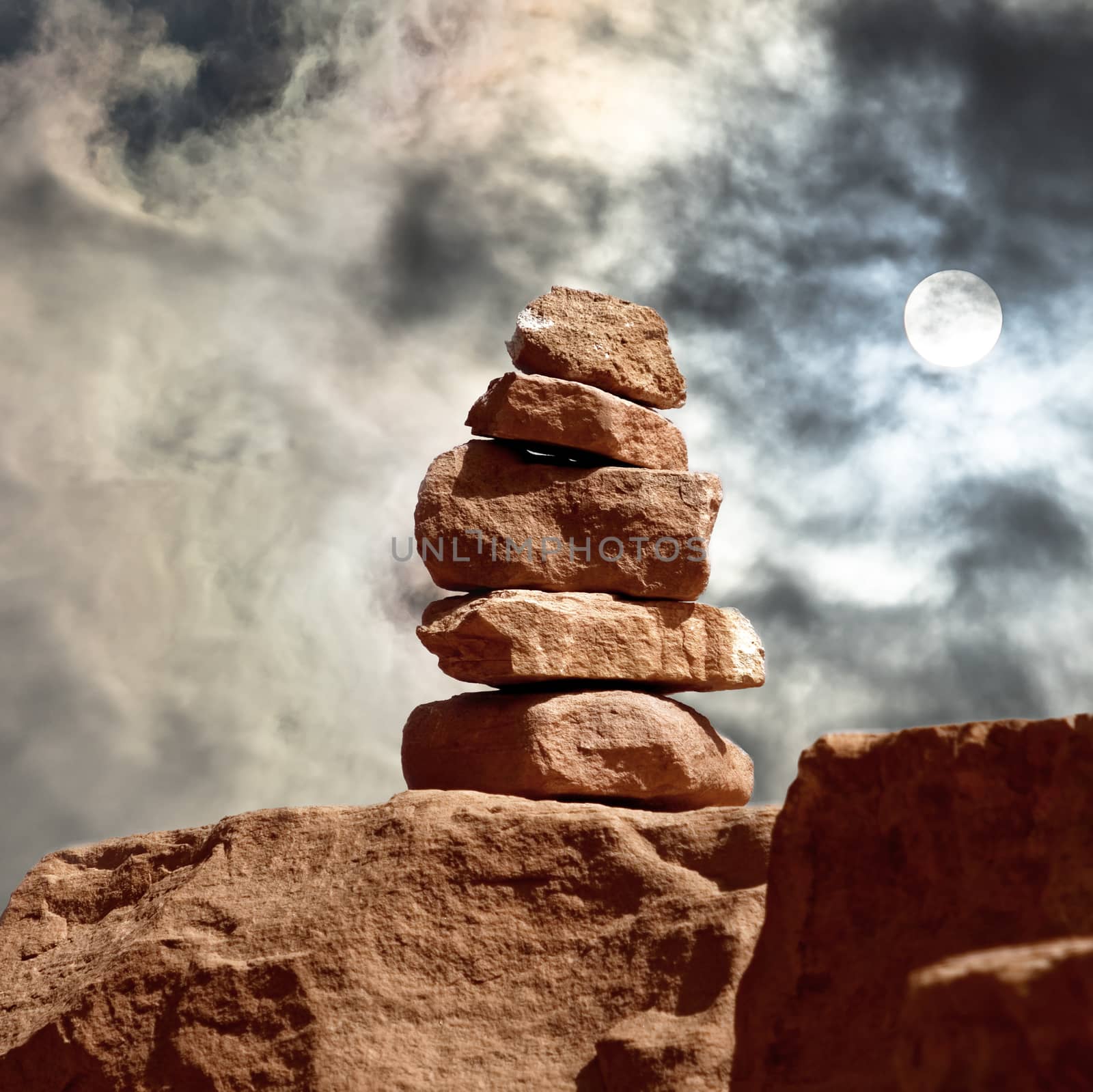 Signposts made of piled stones in Wadi Rum, with a frightening sky in the background by geogif