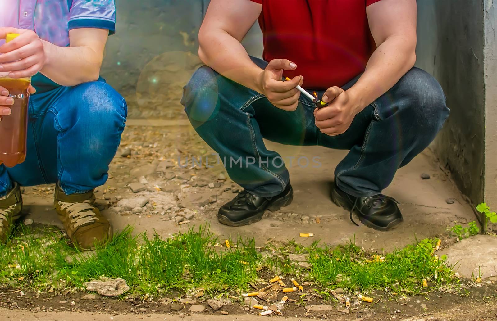 alcoholics, smokers and bad guys sit on the street near cigarette butts by jk3030