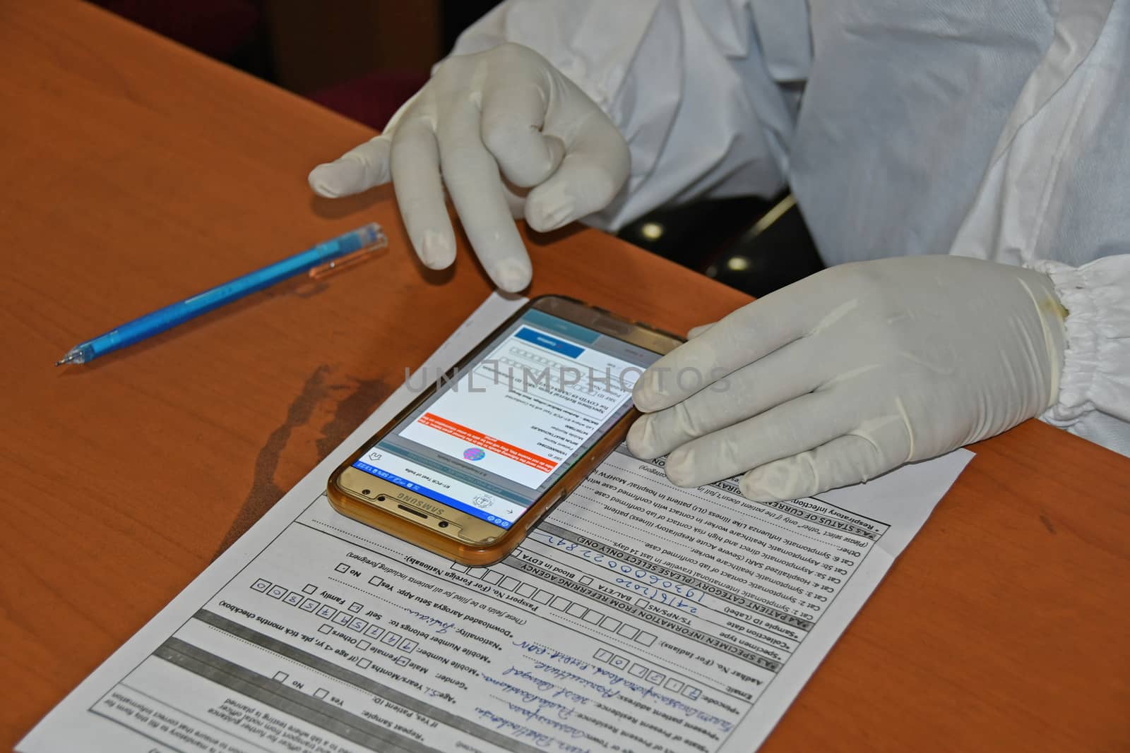 Burdwan Town, Purba Bardhaman District, West Bengal / India - 24.06.2020: Health workers are collecting samples of asymptomatic journalist for COVID-19 (Novel Coronavirus) test in the initiative of Purba Bardhaman District Health Department.