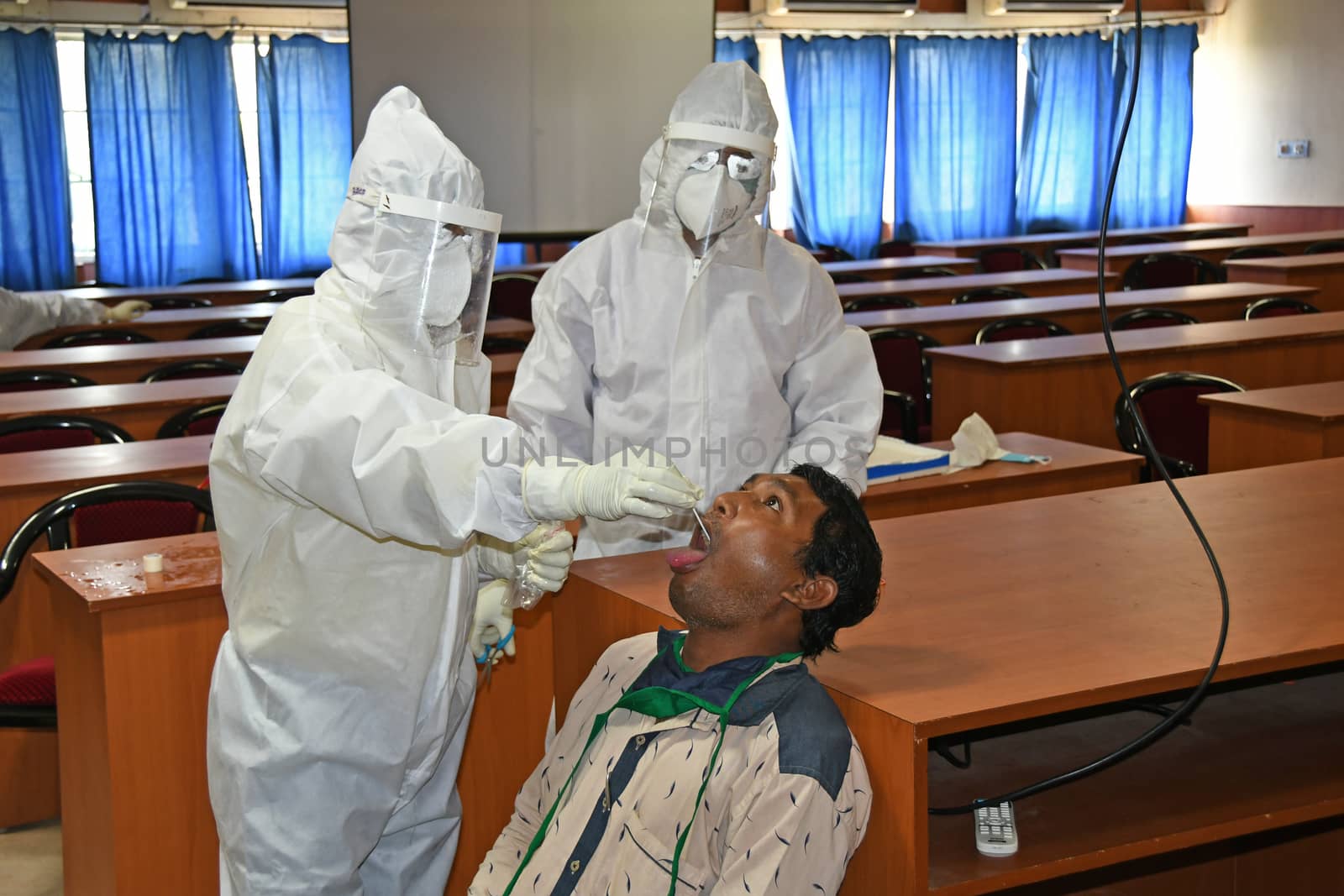 Burdwan Town, Purba Bardhaman District, West Bengal / India - 24.06.2020: Health workers are collecting samples of asymptomatic journalist for COVID-19 (Novel Coronavirus) test in the initiative of Purba Bardhaman District Health Department.