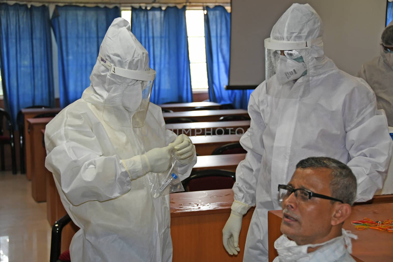 Burdwan Town, Purba Bardhaman District, West Bengal / India - 24.06.2020: Health workers are collecting samples of asymptomatic journalist for COVID-19 (Novel Coronavirus) test in the initiative of Purba Bardhaman District Health Department.