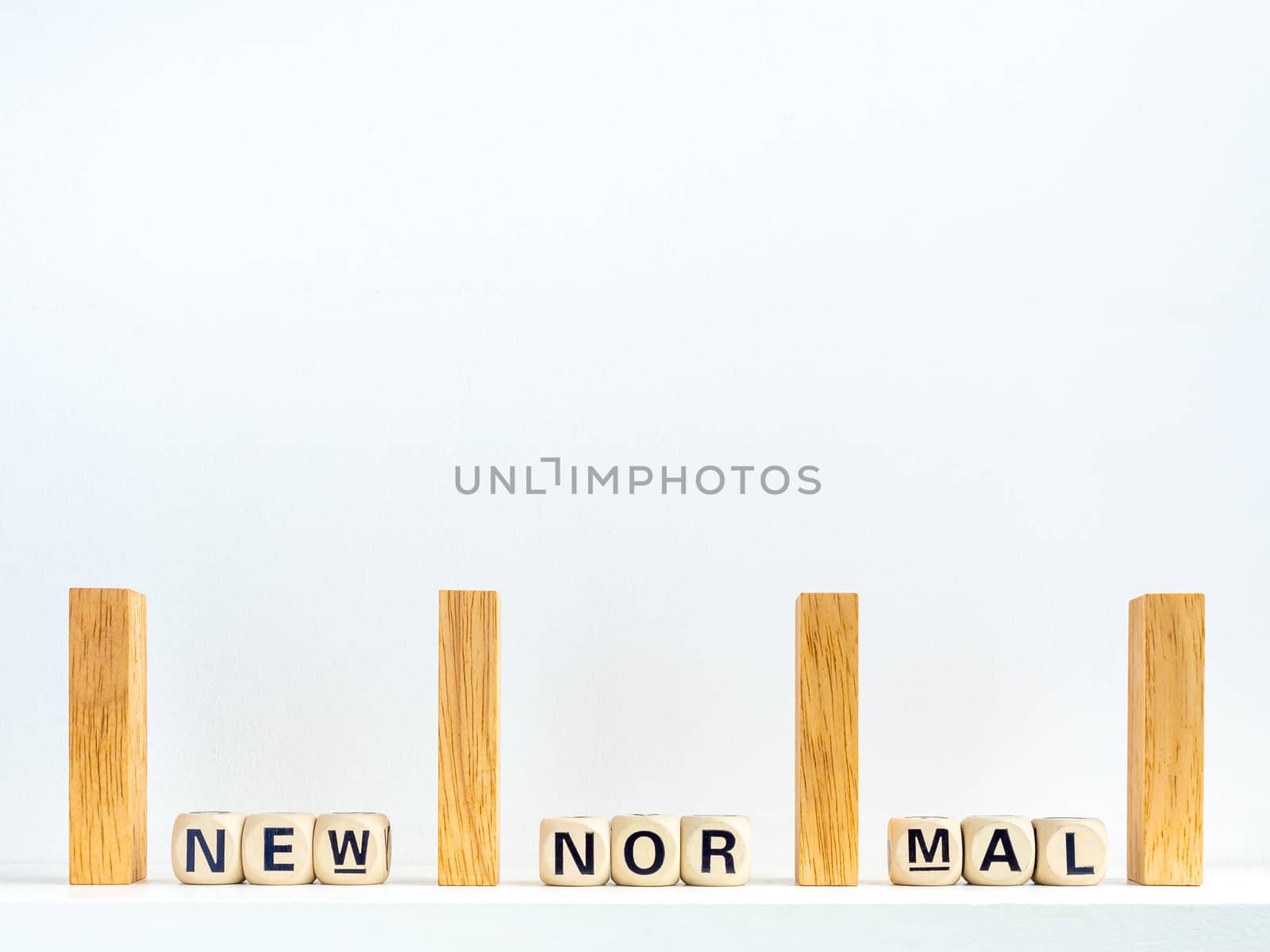 Social Distancing concept. Row of wooden dominoes with distance space and New Normal, words on wooden alphabet cube on white background with copy space.