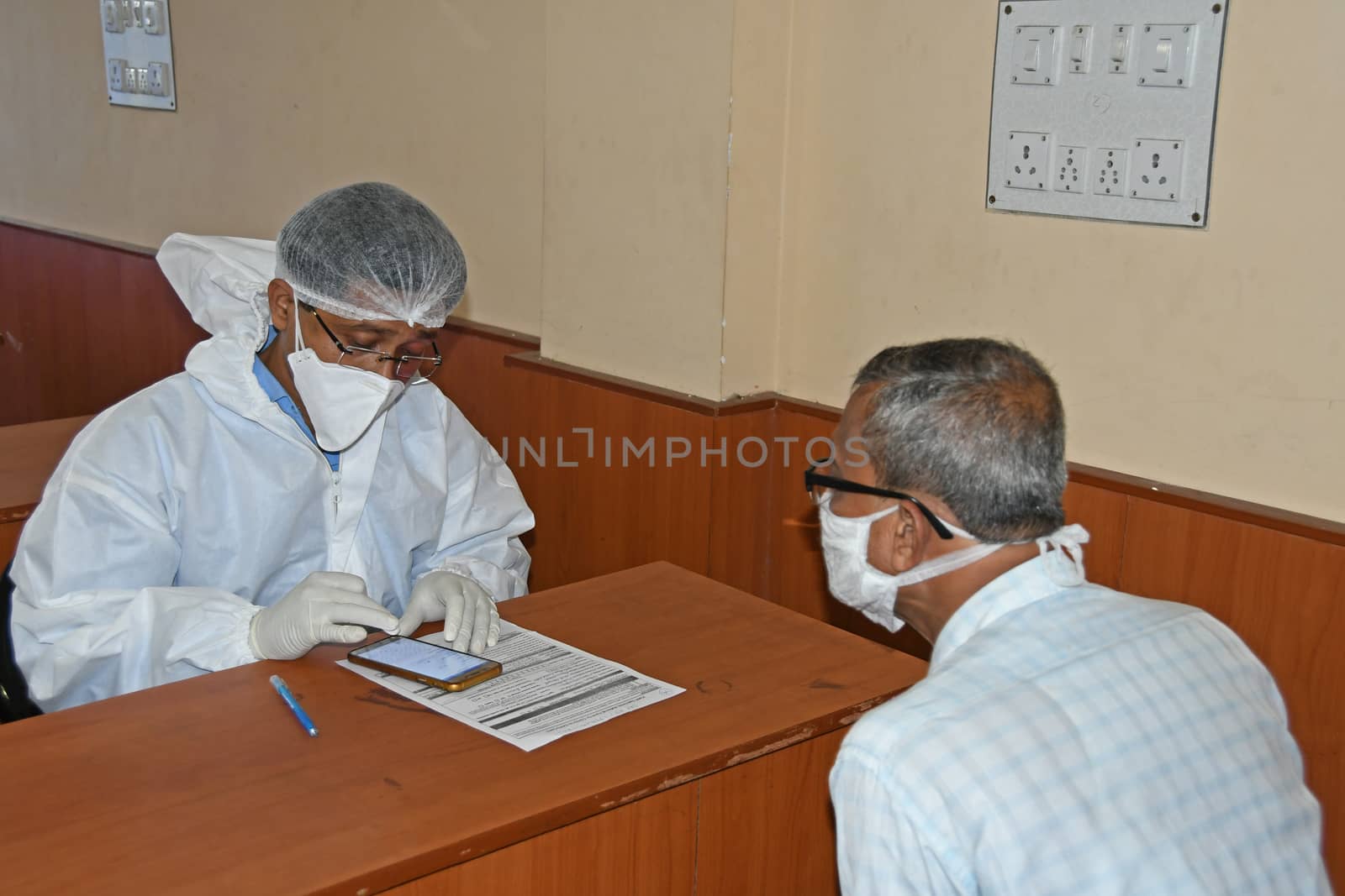 Burdwan Town, Purba Bardhaman District, West Bengal / India - 24.06.2020: Health workers are collecting samples of asymptomatic journalist for COVID-19 (Novel Coronavirus) test in the initiative of Purba Bardhaman District Health Department.