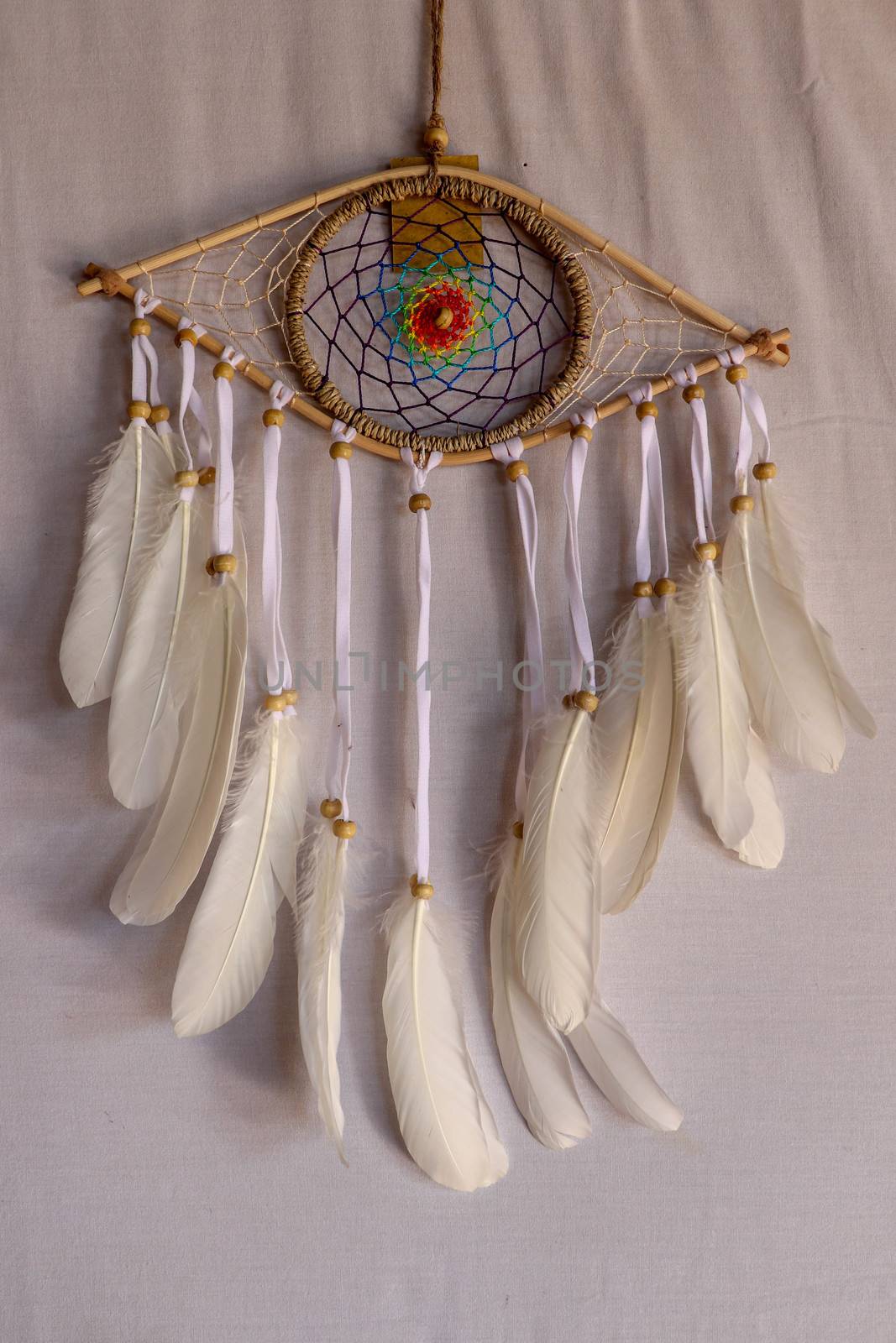 god eye of providence dreamcatcher with white feathers on a white background.