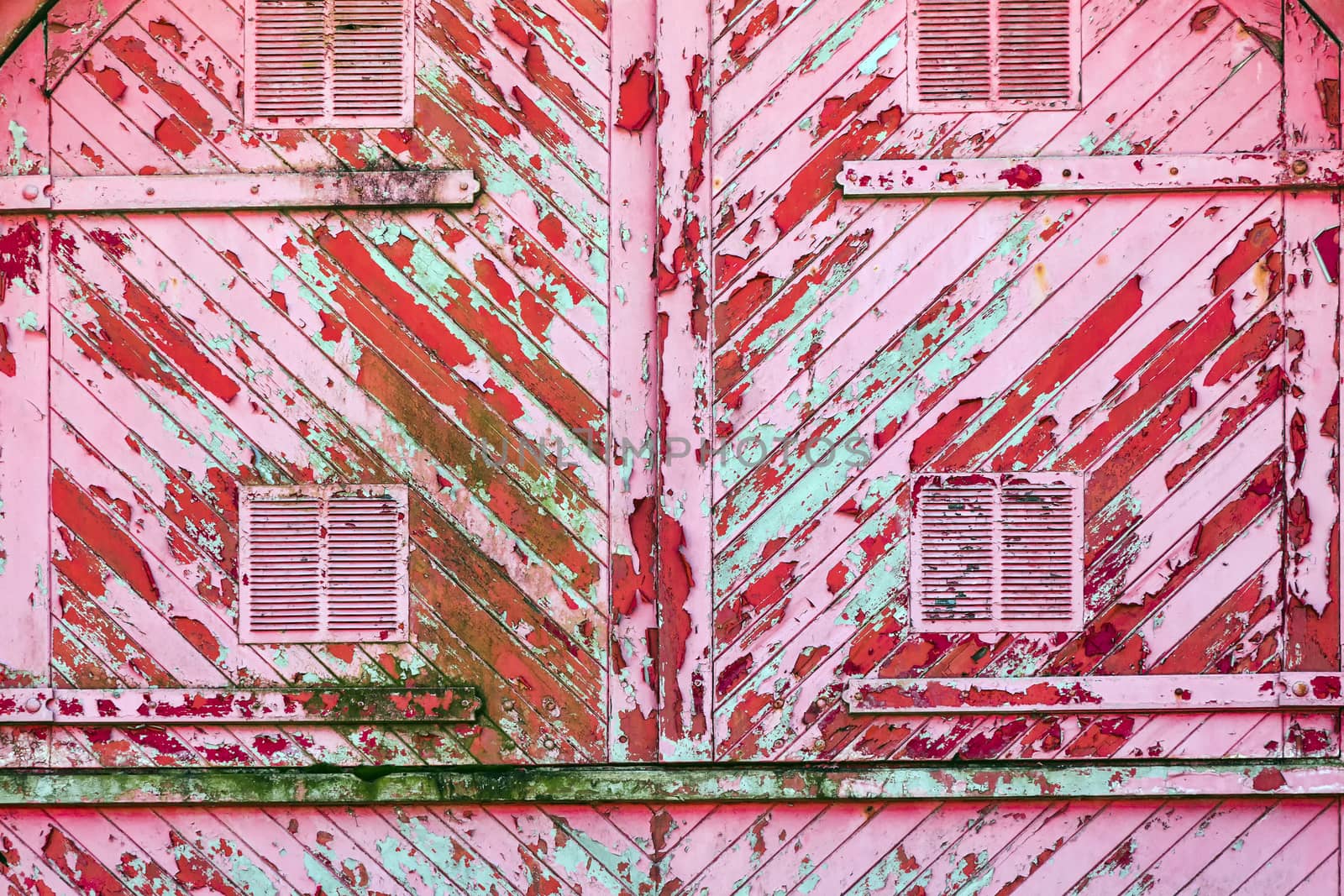 Old pink red weathered distressed wood planks texture background