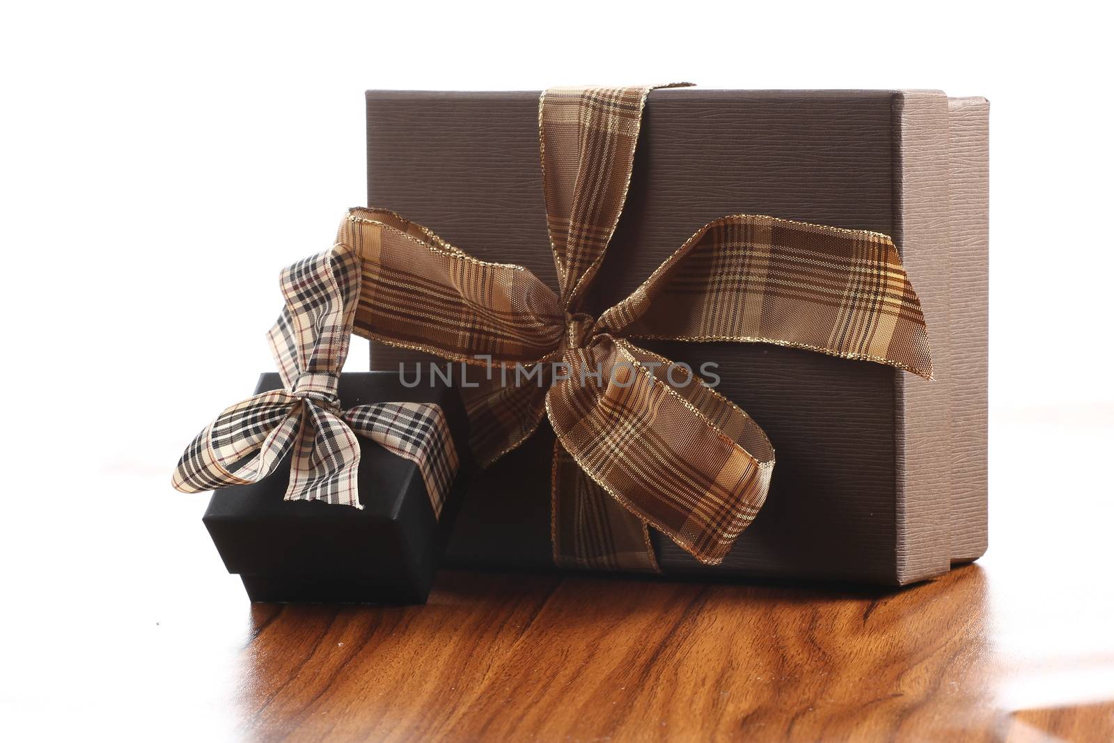 Presents on a table with a bow. Background space for copy. For Christmas, birthday or other holiday cards