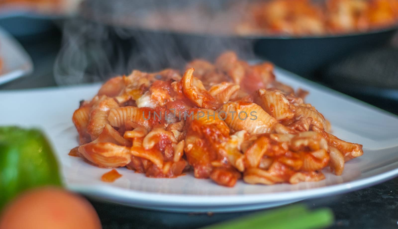 pasta bake steaming hot on a plate by sirspread