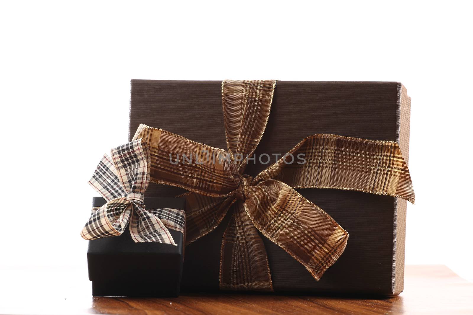 Presents on a table with a bow. Background space for copy. For Christmas, birthday or other holiday cards