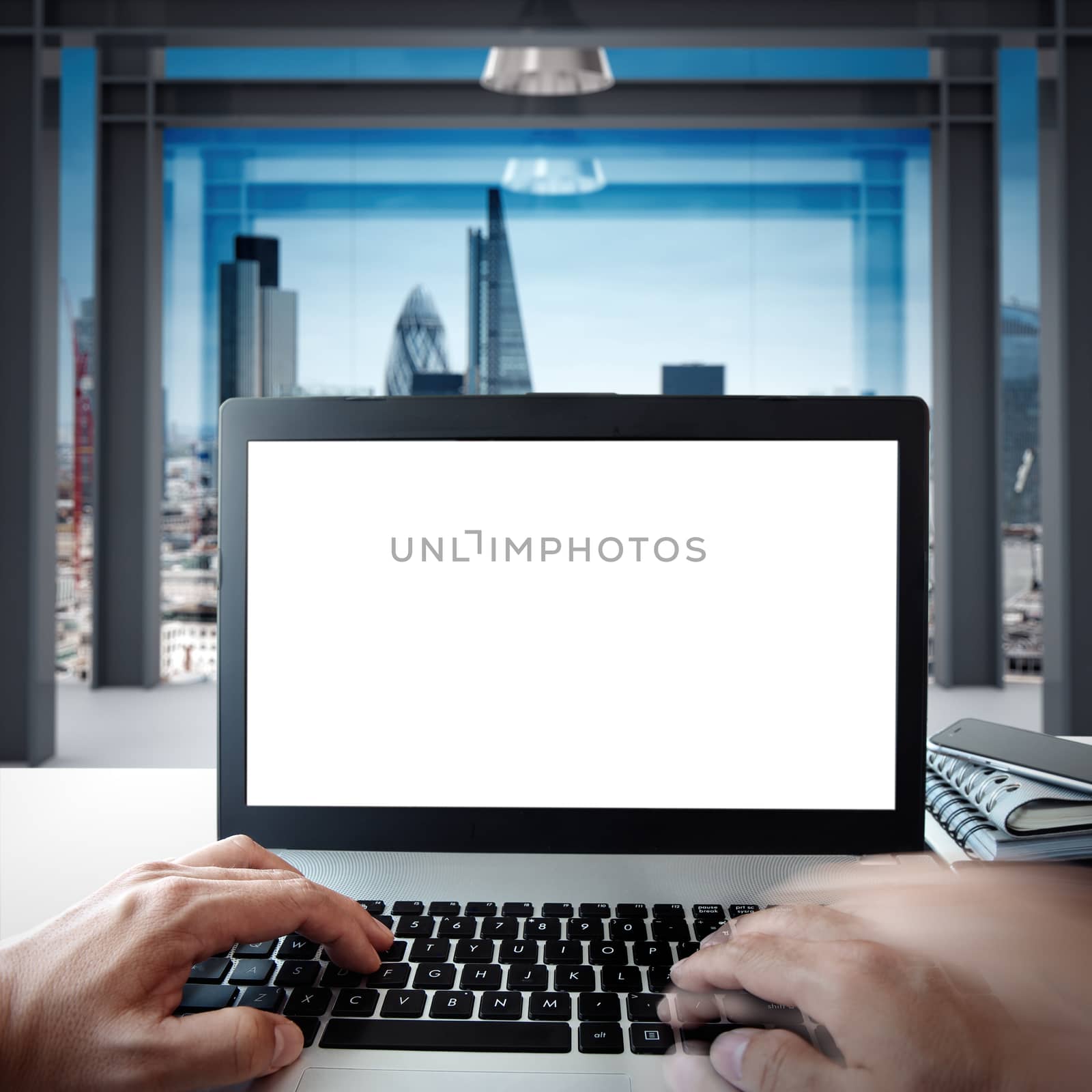 hands using Laptop with blank screen on white desk with blurred background as concept