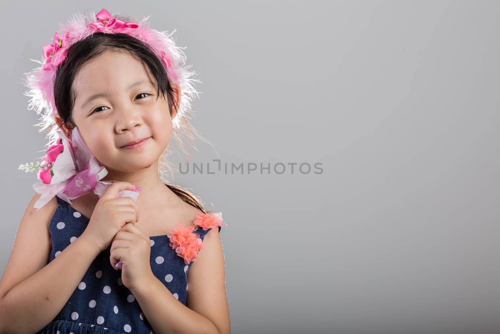 Background of Asian girl holding flowers in her hands.