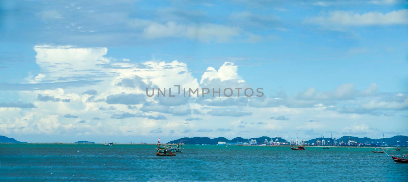 Panorama fishing boat and sailing on the sea industry background and blue sky