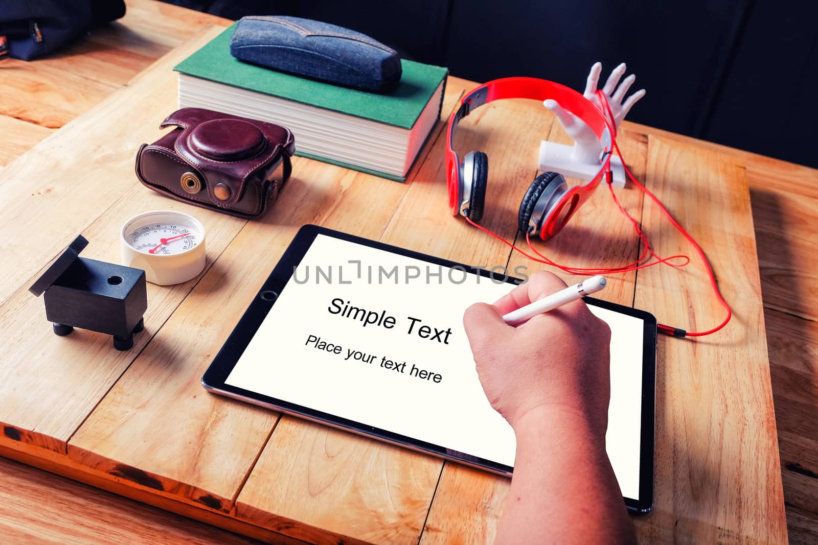 
Office workplace with tablet and headphone on wood table.