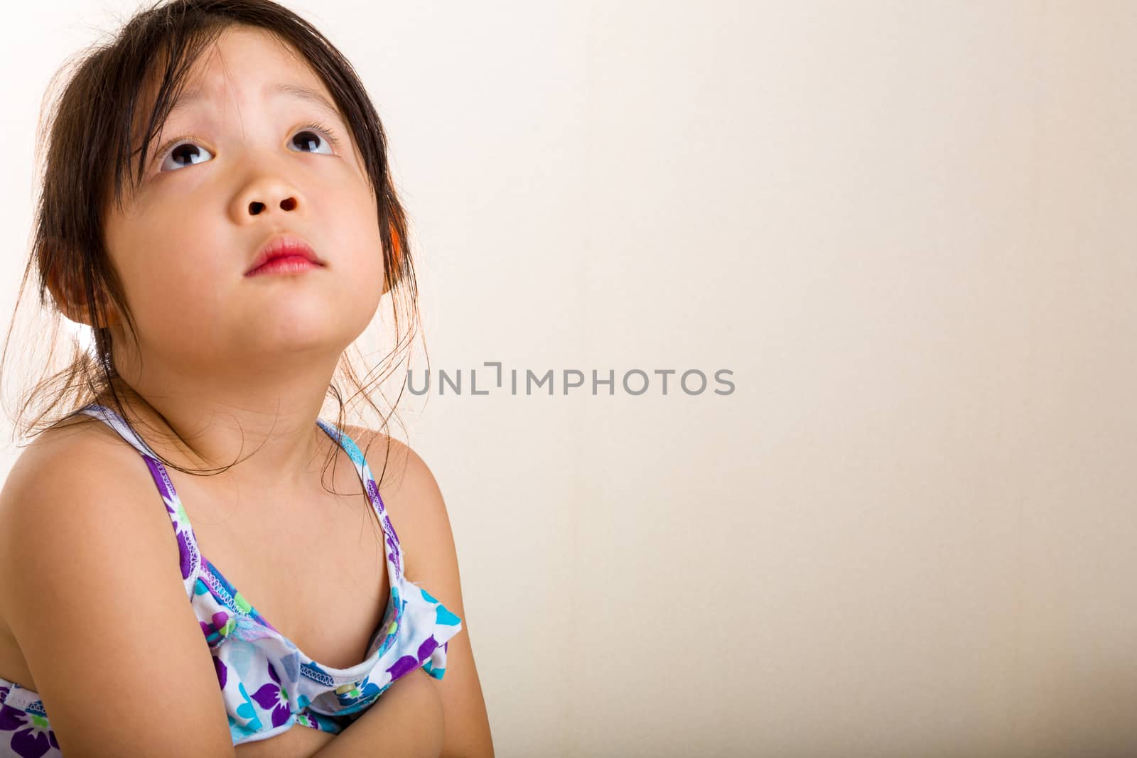 Little girl with lonely emotion sitting alone by herself.