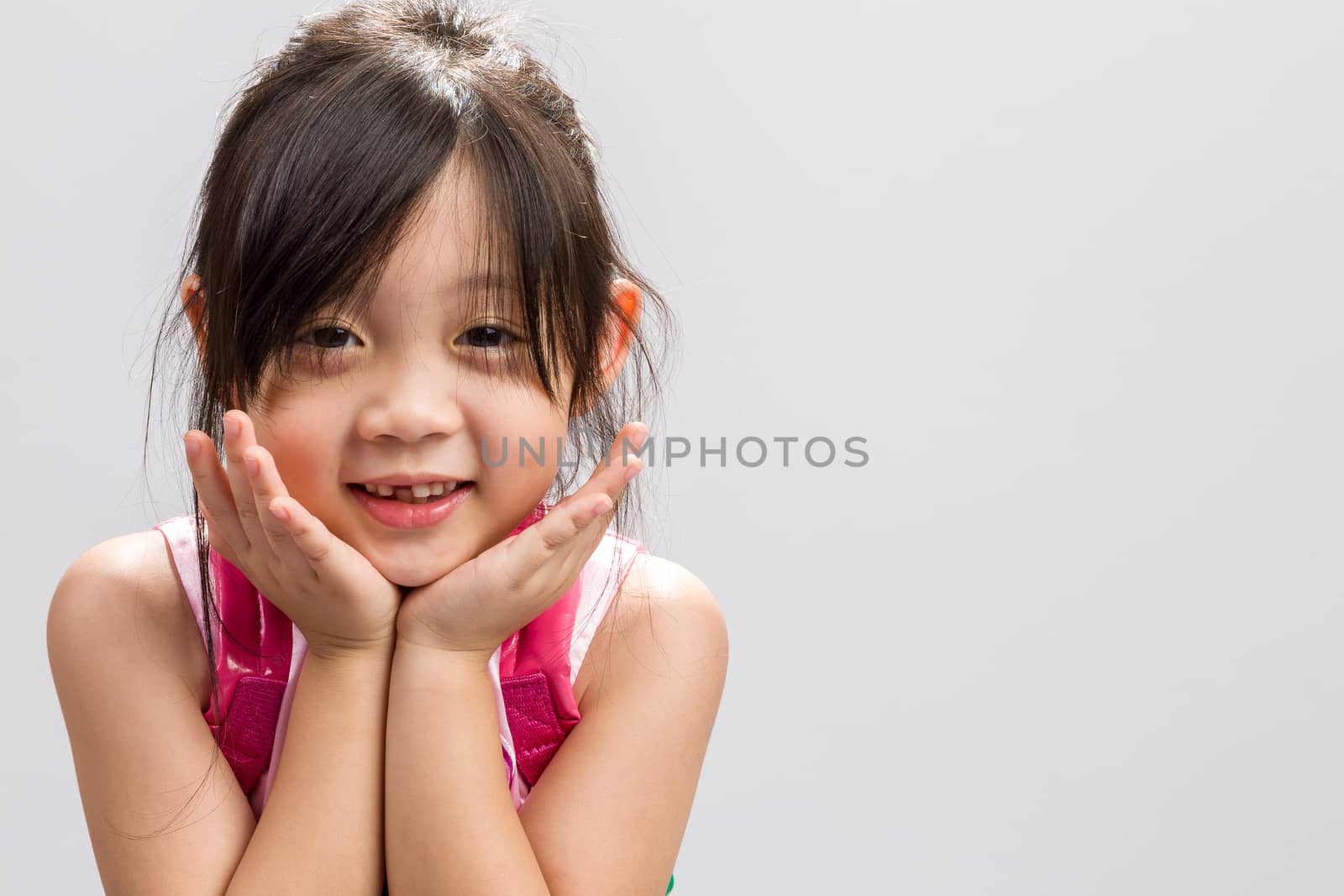 Cute Asian girl smiling, studio isolated white background.
