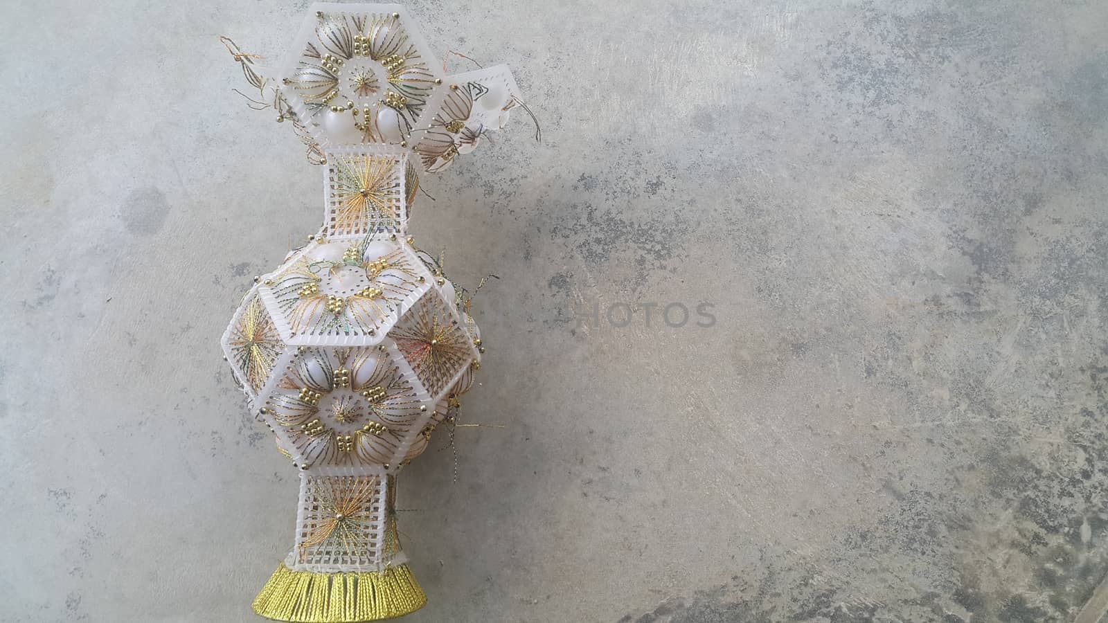 A beautiful ceramic vase placed on a grey floor used for flowers or bouquet by Photochowk