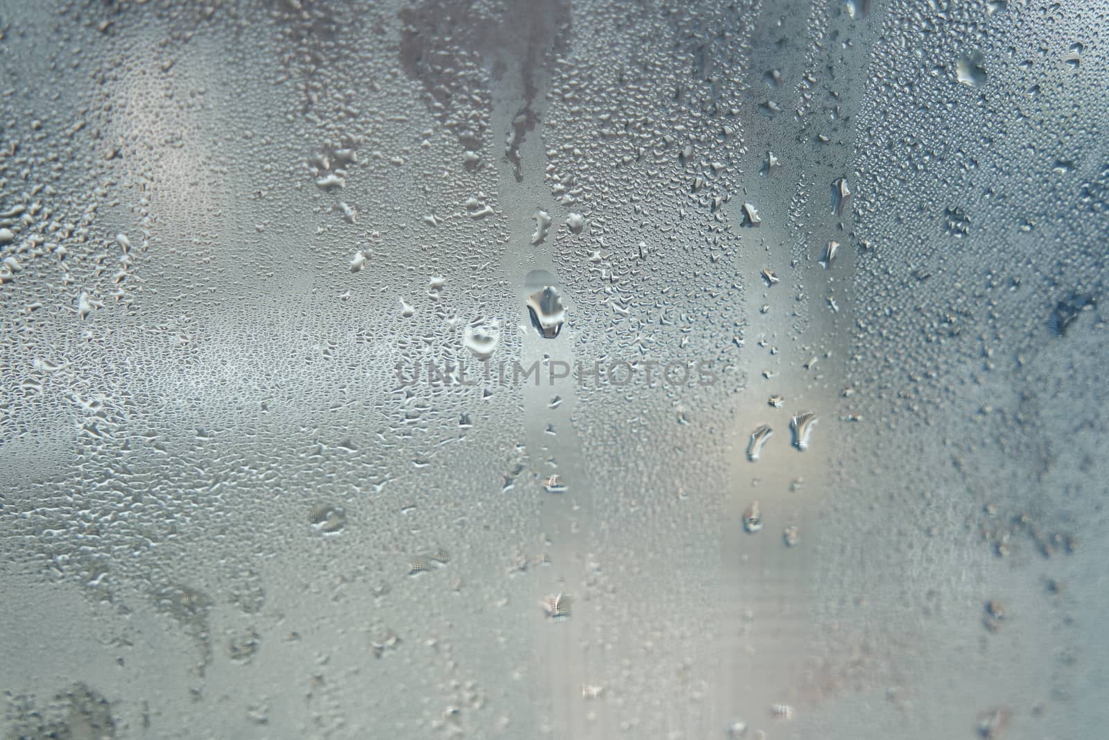 Bright grey color glassy texture, with water drops on it: abstract background