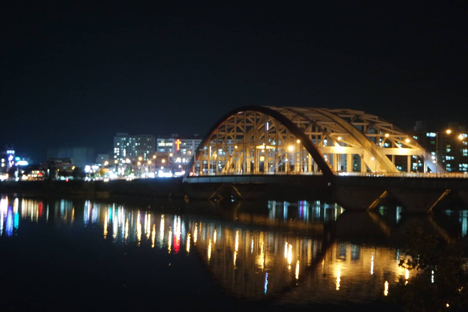 Night view of a beautiful scene of bridge over sea water in the evening time. by Photochowk