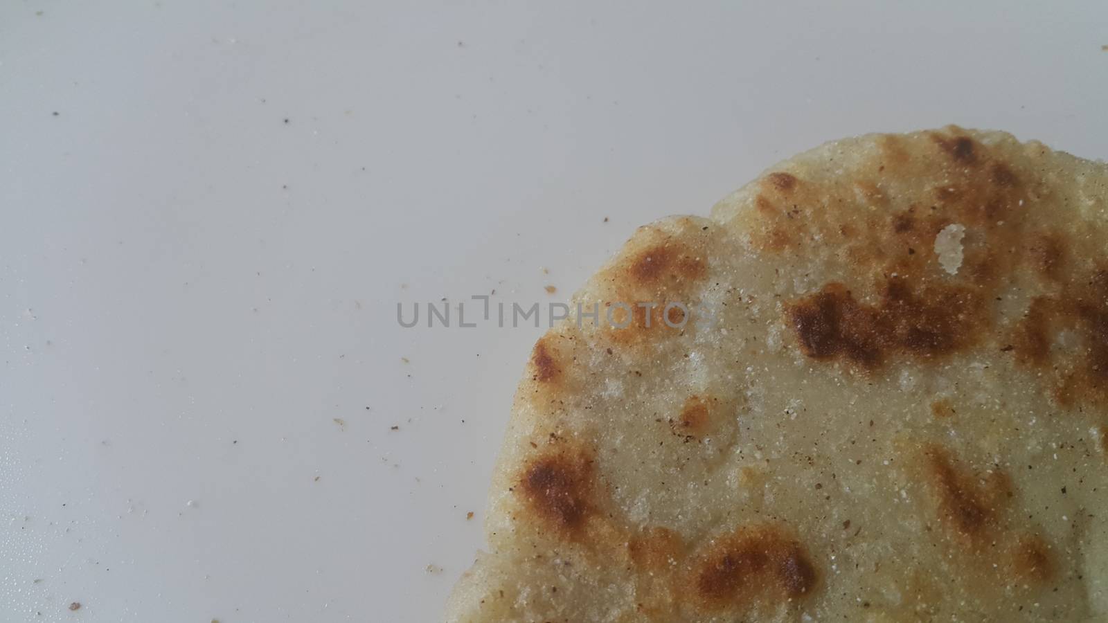 Closeup view of of traditional bread called Jawar roti or bhakri on white background. Bhakri is a round flat unleavened bread often used in the cuisine of many Asian countries