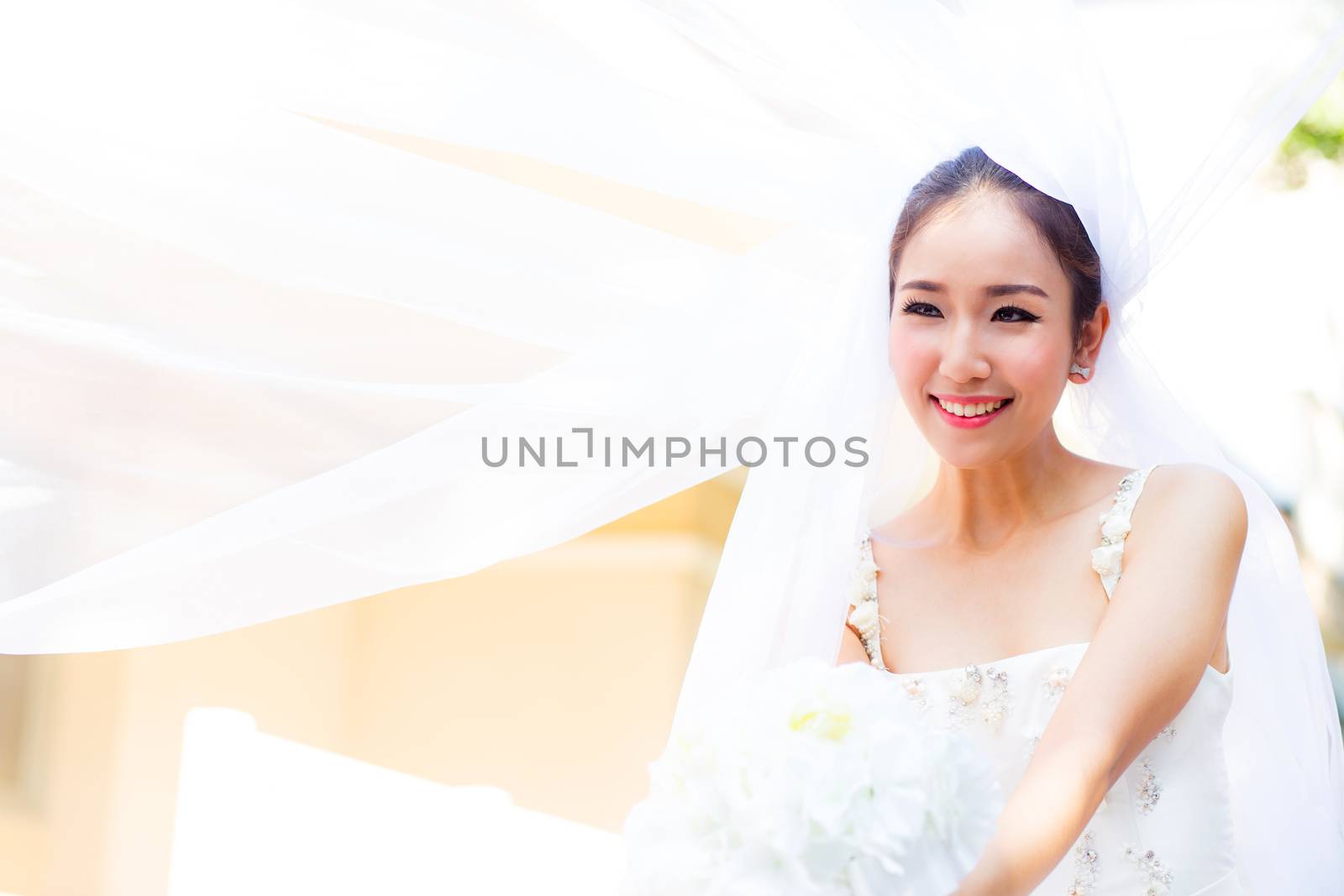 beautiful young woman on wedding day in white dress in the garden. Female portrait in the park.