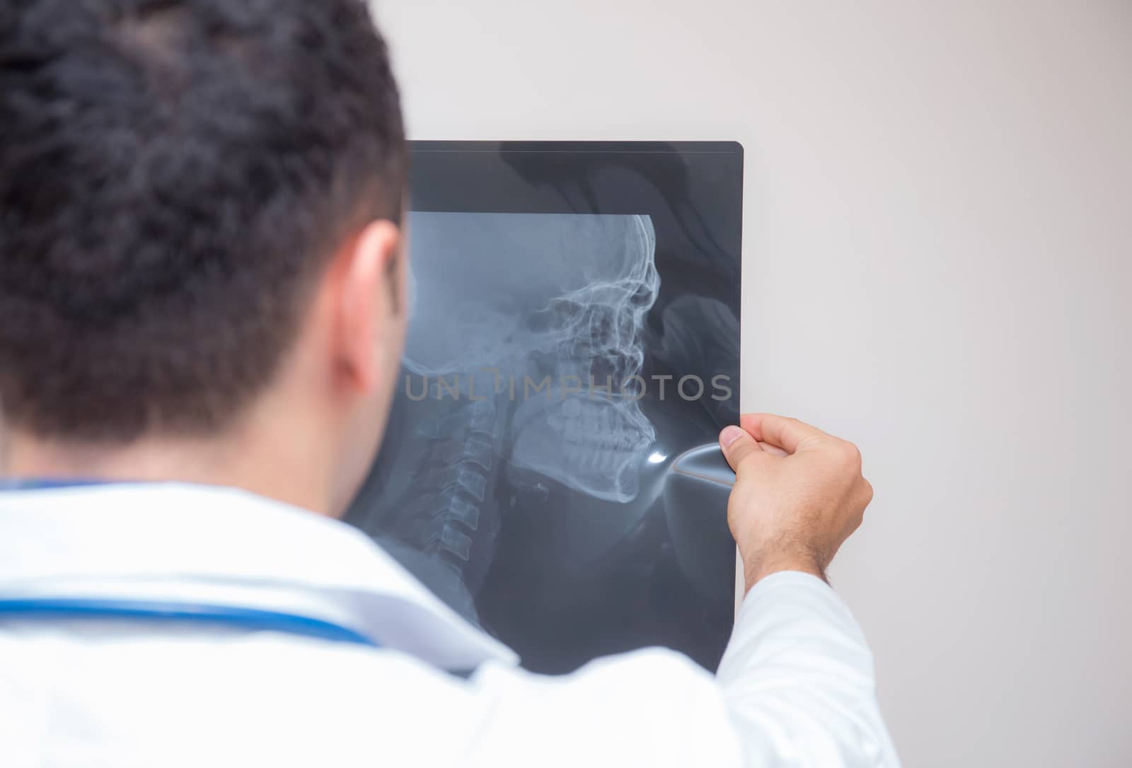 healthcare with roentgen - people and medicine concept - male doctor in white coat looking at x-ray isolated on white background