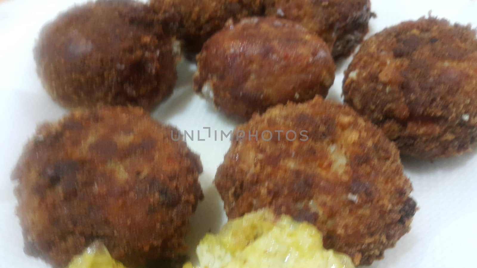 Delicious spicy fried round kebab served in white ceramic plate by Photochowk