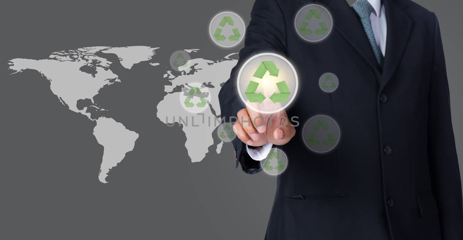 business man pointing at green recycle symbol with world map background, Elements of this image furnished by NASA