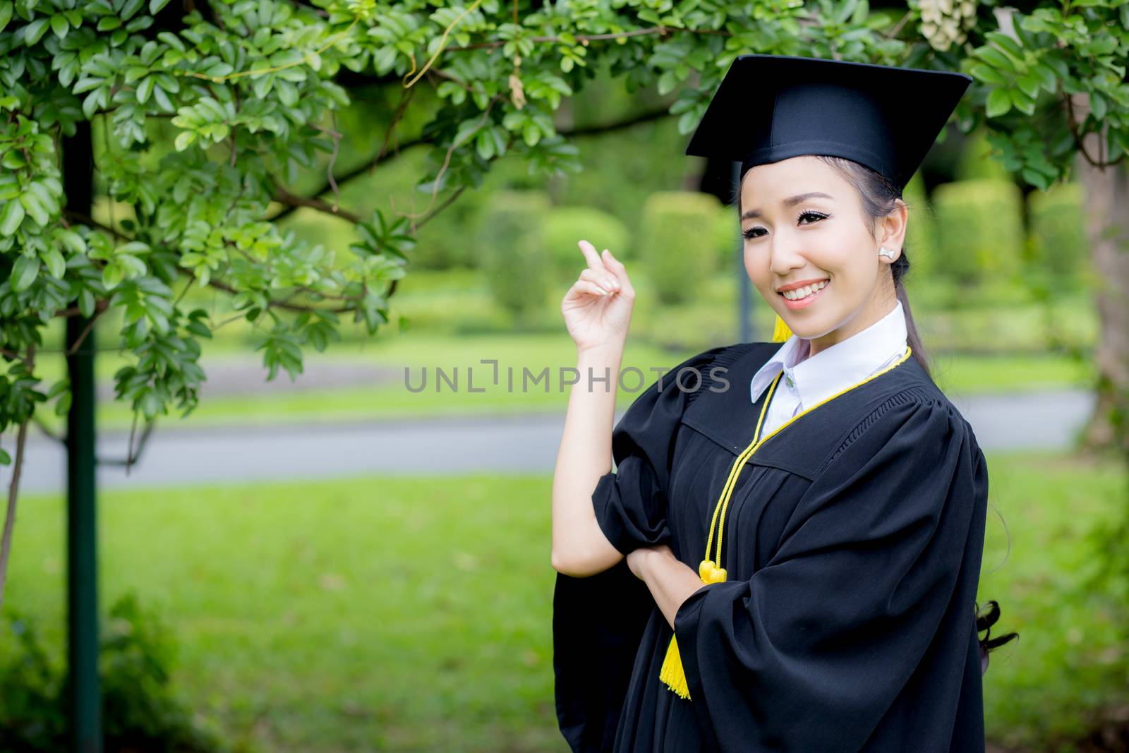 people, graduation pointing finger with something, education concept