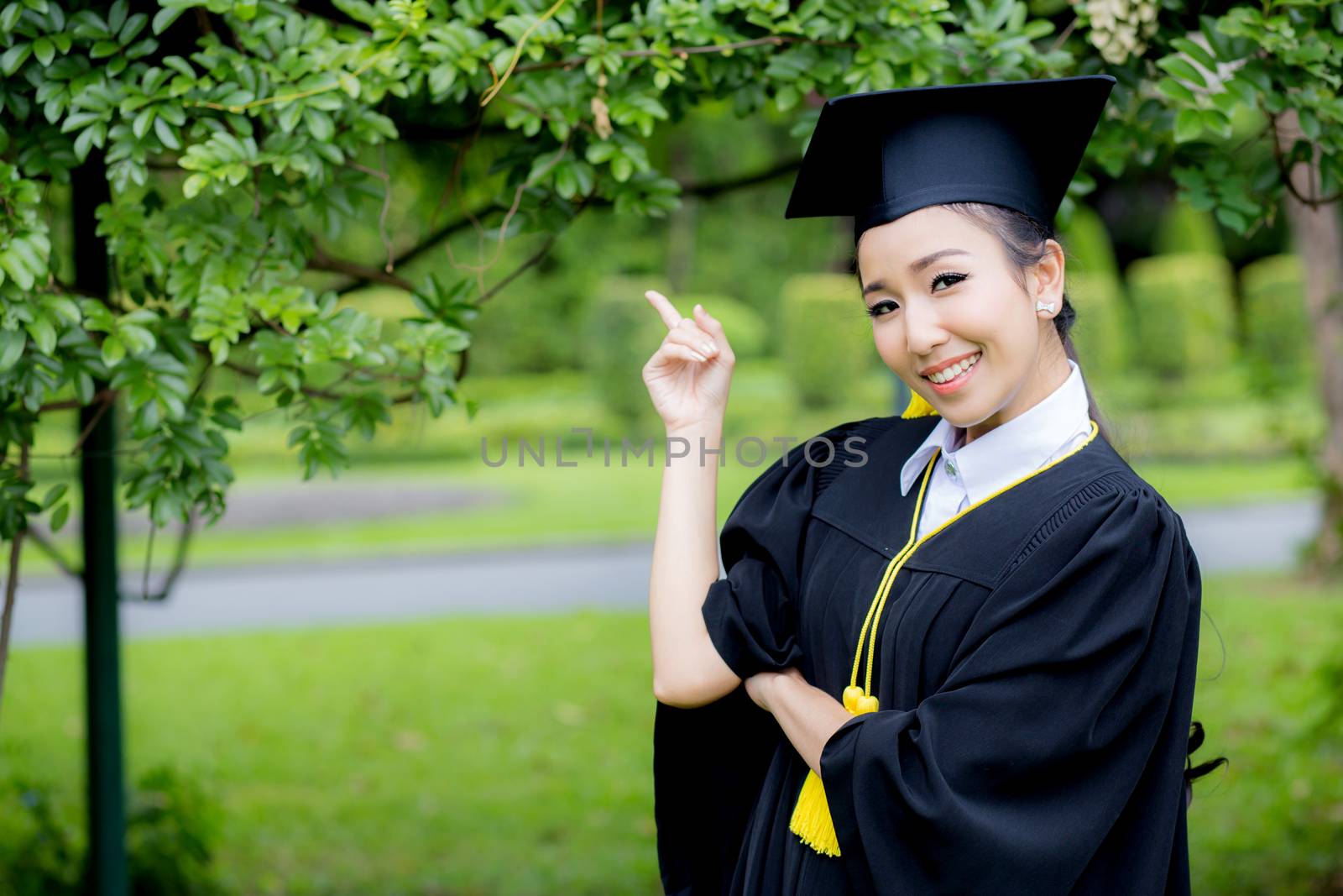 people, graduation pointing finger with something, education concept