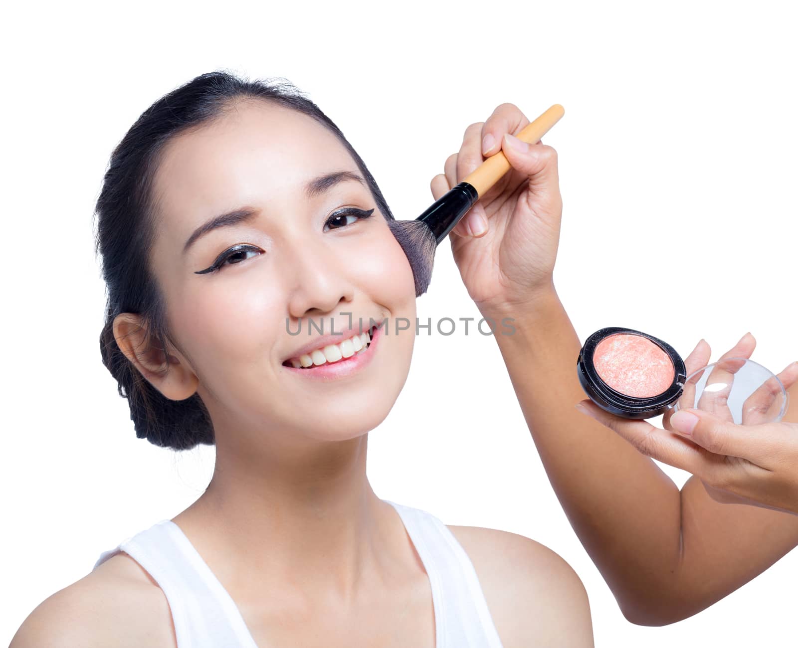 Young beautiful woman using a make-up brush, bright natural background, woman with beauty Face