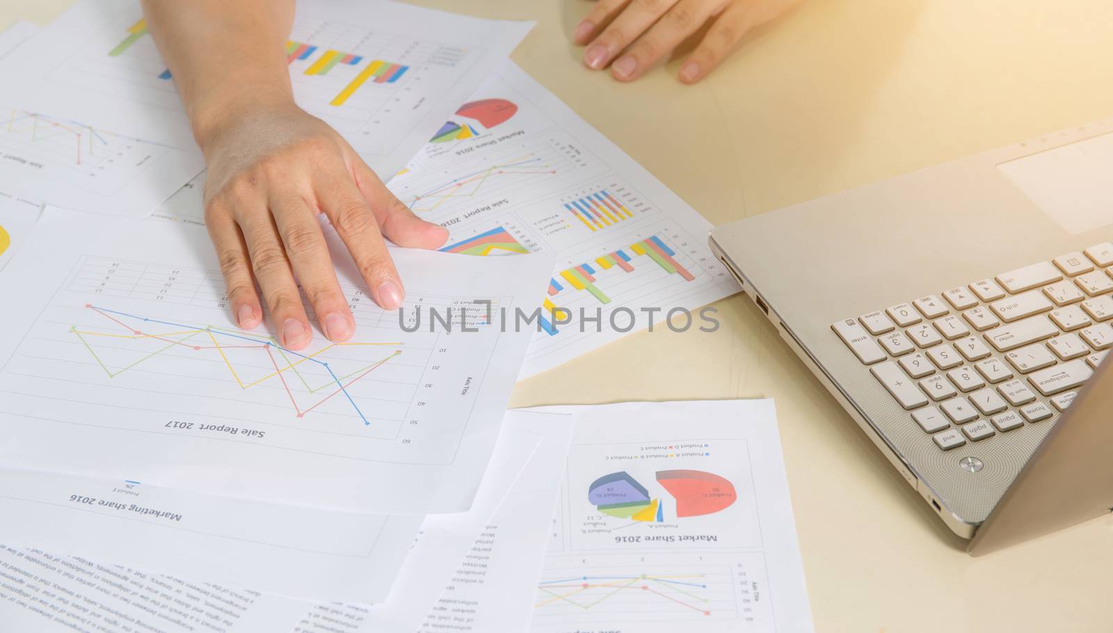 Financial paper charts, graphs and notebook on the table