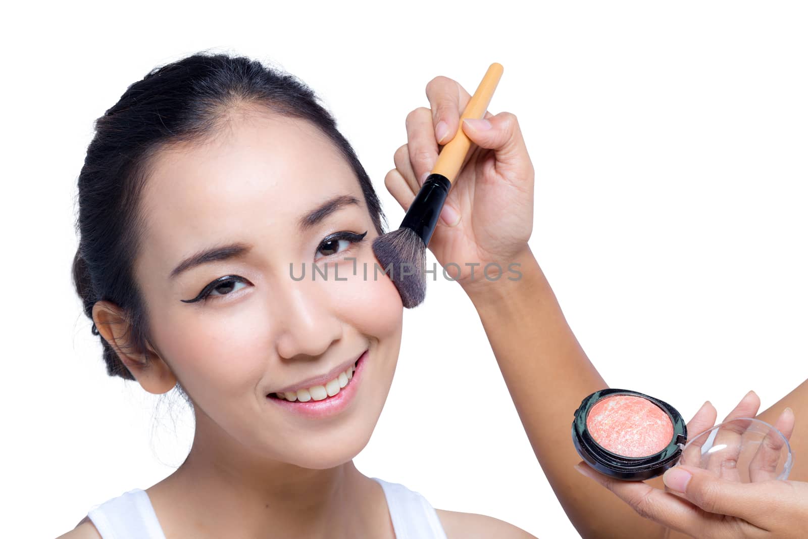 Young beautiful woman using a make-up brush, bright natural back by nnudoo