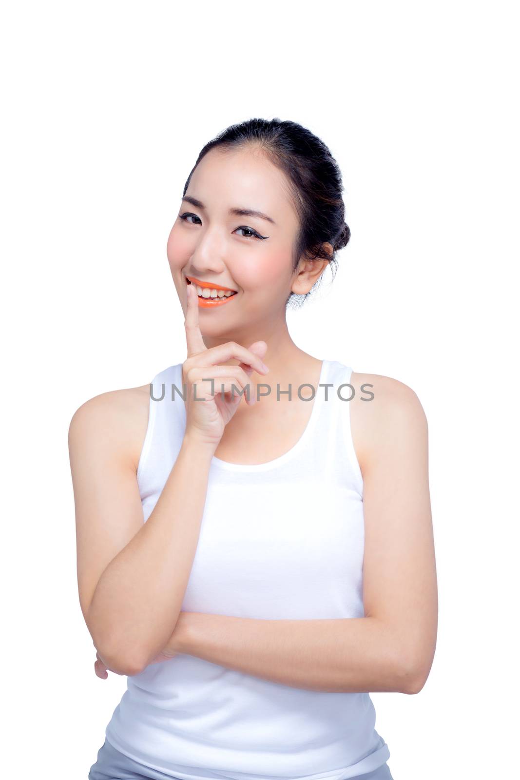 Beautiful model girl with lips woman hold a finger on her mouth a secret with smile