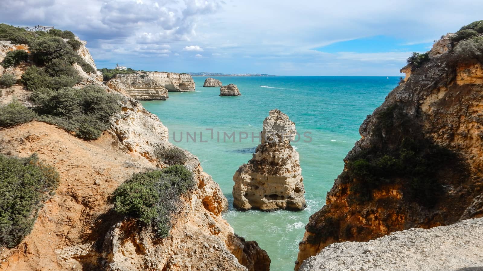 Panoramic view of the Algarve ocean cliffs, Portugal, with cloudy dramatic sky by robbyfontanesi