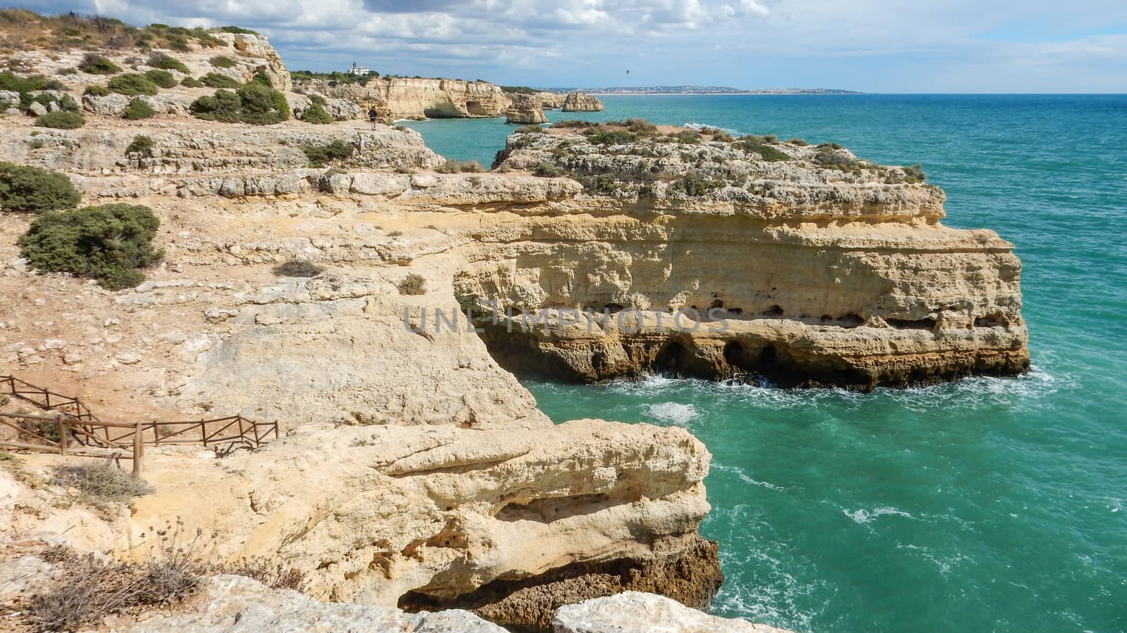 Panoramic view of the Algarve ocean cliffs, Portugal, with cloudy dramatic sky by robbyfontanesi