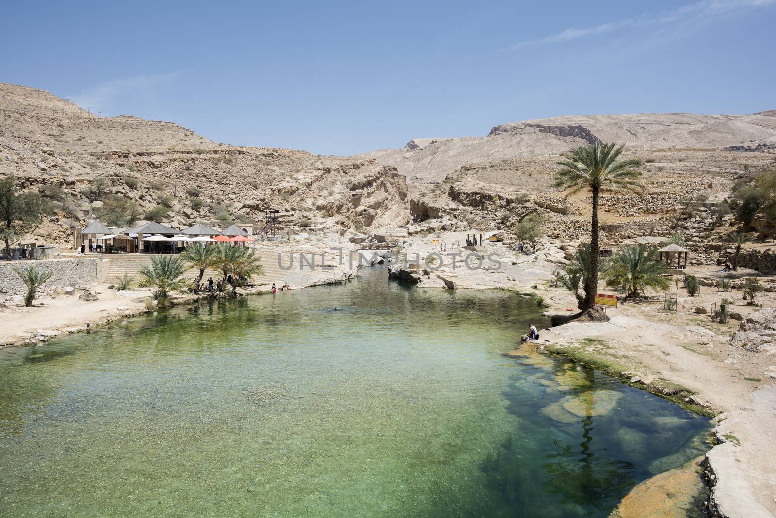 Tourists around Main pool of Wadi Bani Khalid, Oman by GABIS
