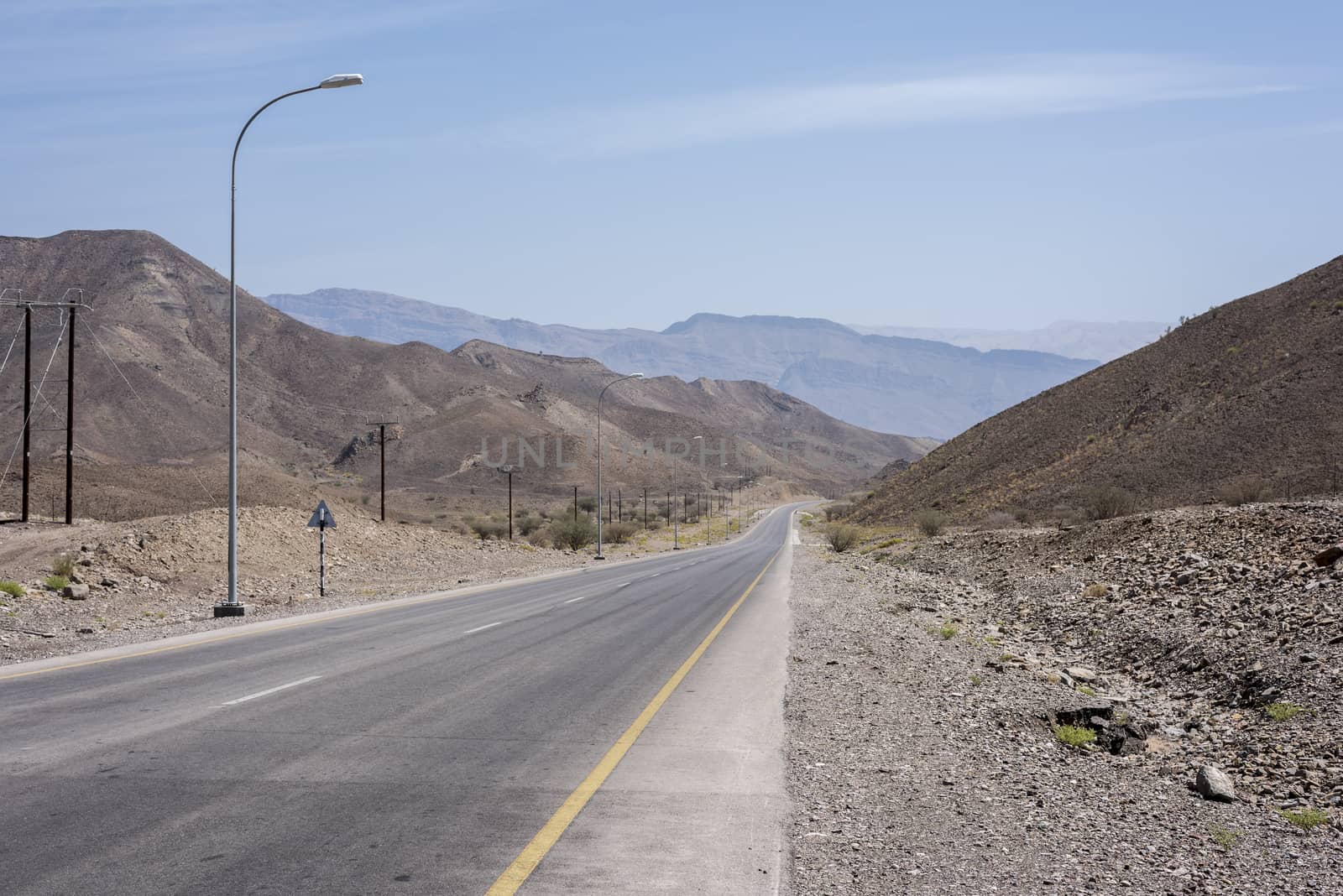 Empty road in Oman wild and arid mountains by GABIS