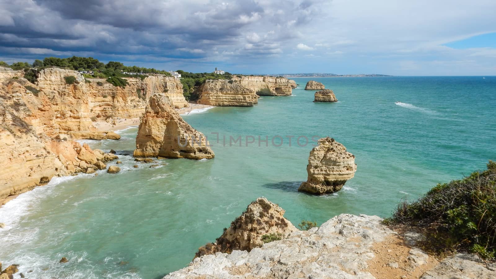 Panoramic view of the Algarve ocean cliffs, Portugal, with cloudy dramatic sky by robbyfontanesi