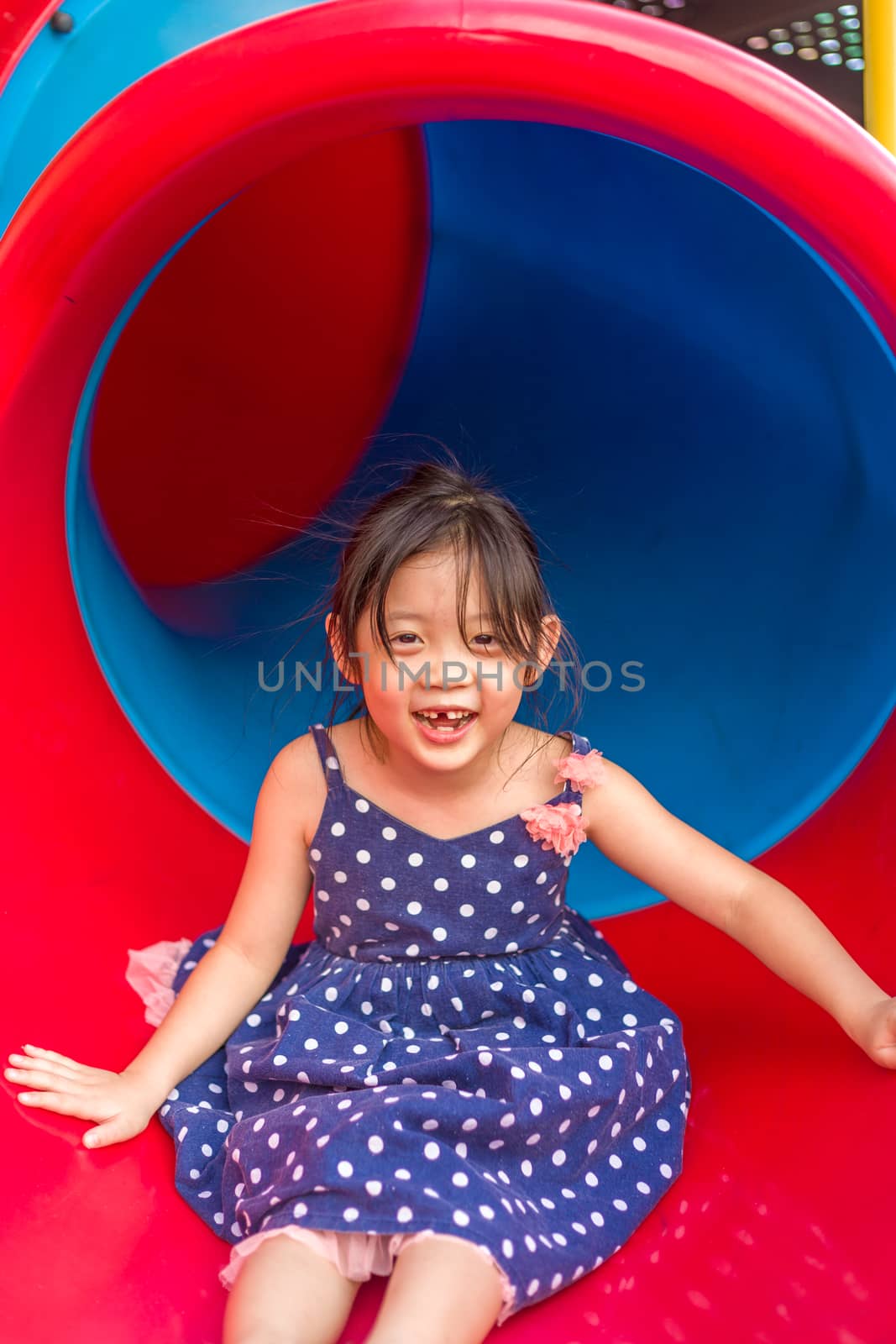 Child Playing on Playground / Happy Child Playing on Playground by supparsorn