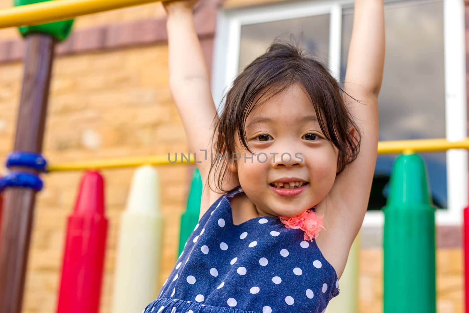 Little Girl Playing on Playground / Happy Little Girl Playing on by supparsorn