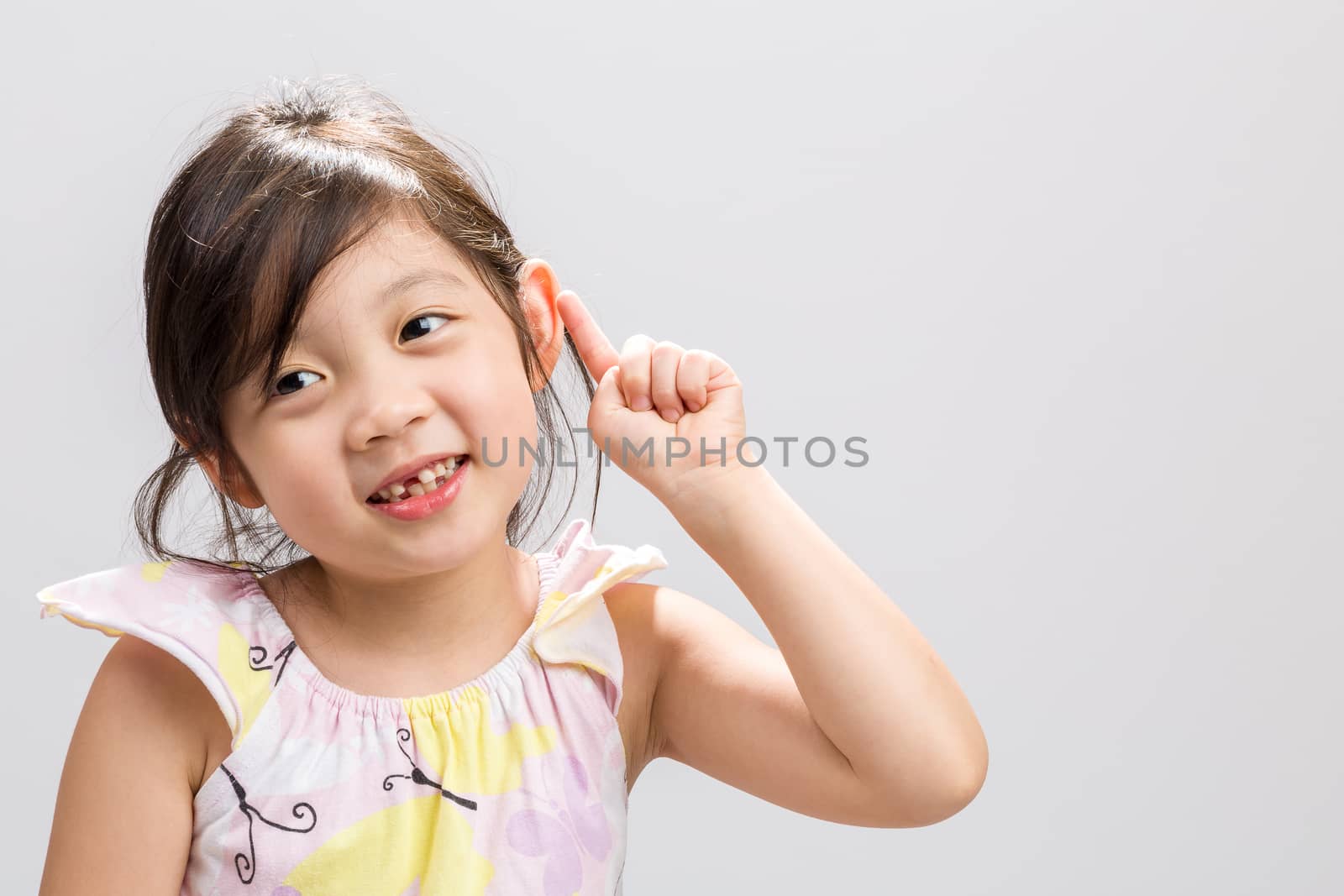 Cute Asian girl expressing smart concept, studio isolated white background.
