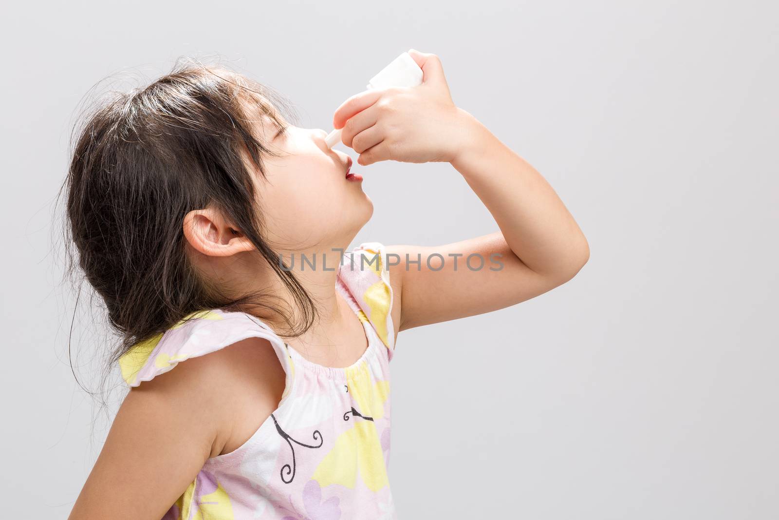 Child Using Nasal Spray Background / Child Using Nasal Spray / C by supparsorn
