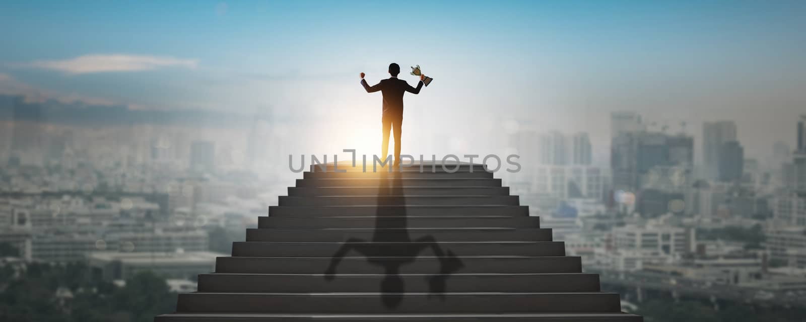 highest goal achievement and success concept, successful business man, leader businessman, winner climbing up to top of high stair way of city show hand up, holding award,  trophy of investment step