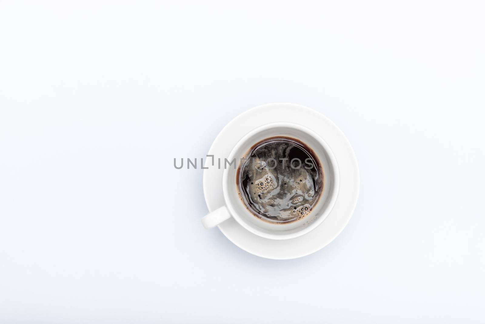 white cup with coffee on a white background with a place for text by marynkin
