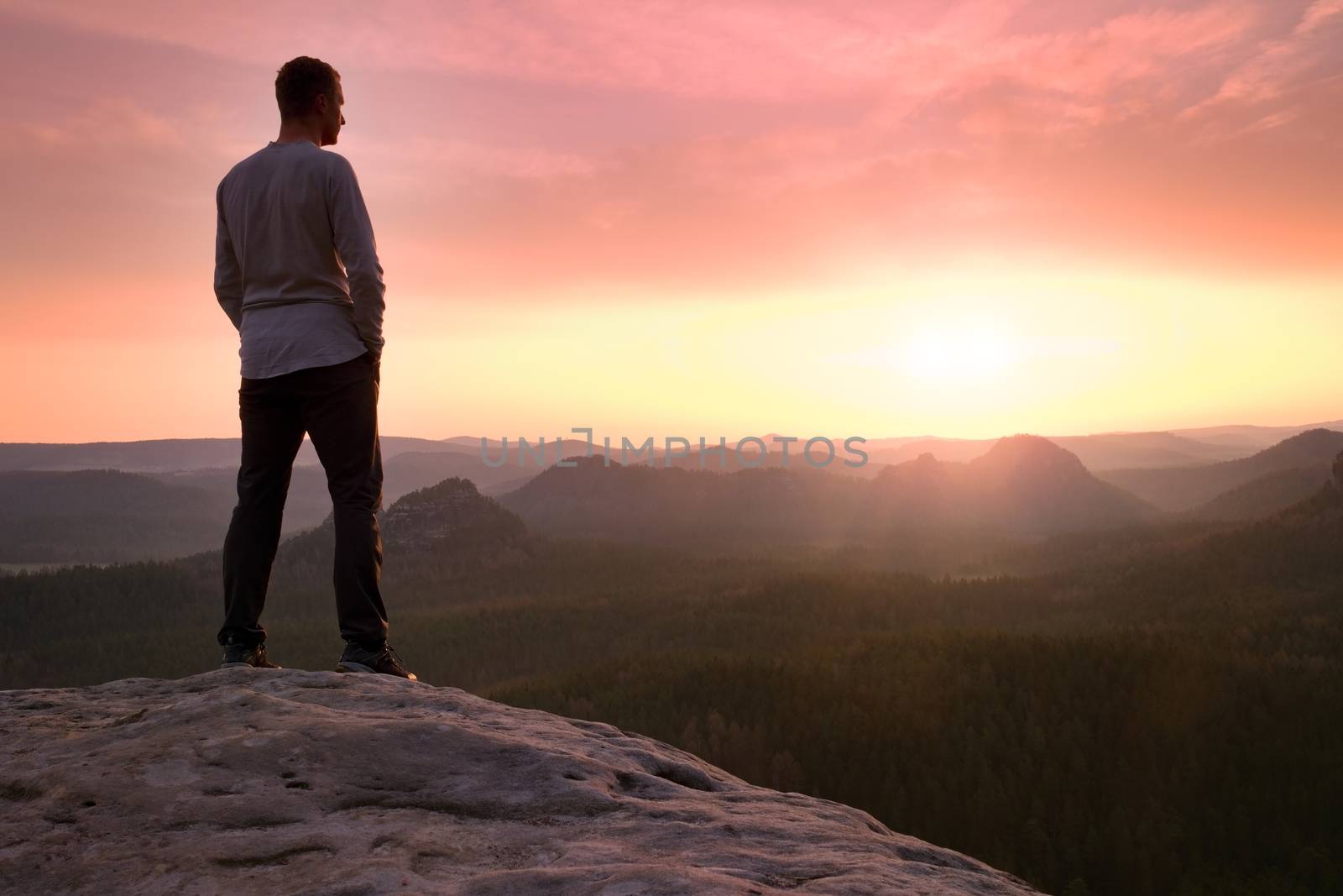 Silhouette of Young Confident and Powerful Man Standing with Hands on Hips, Late Day Sun with Copy Space